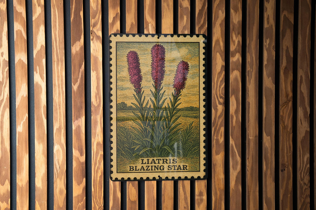 A framed illustration of three pink flowers is displayed on a wooden wall.