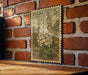 A vintage postage stamp featuring a white lilac flower is displayed on a brick wall.