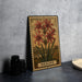 a framed illustration of red lilies on a wall, with the word "NERINE" written below the flowers.