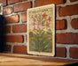 a vintage-style stamp or postcard with a floral illustration, hanging on a brick wall.