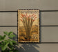 A postage stamp featuring a cactus plant with red flowers, mounted on a wall.