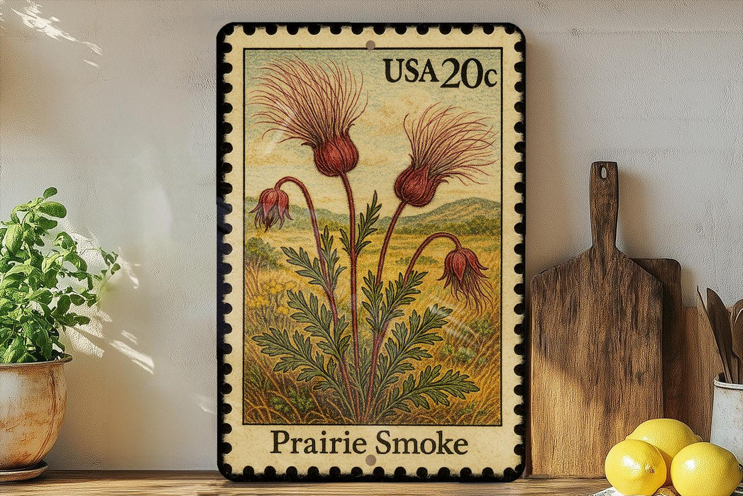 A framed postage stamp depicting a prairie smoke plant, with a wooden cutting board and a potted plant in the background.