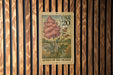 A USA 20 postage stamp featuring a floral illustration of a plant, with the text "Queen of the Prairie" printed on it.
