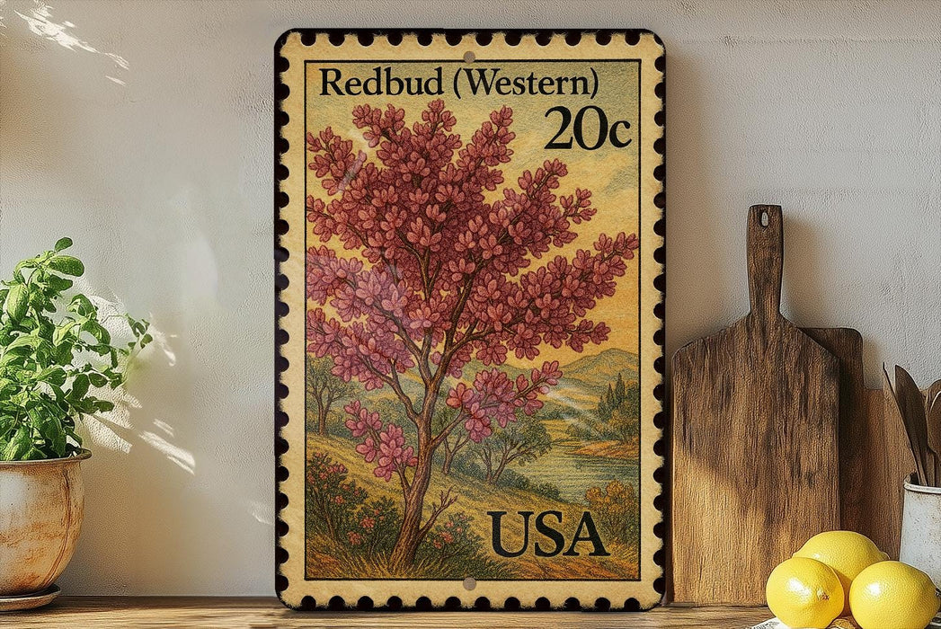 A framed postcard with a vibrant illustration of a redbud tree, placed on a shelf next to a wooden cutting board and a potted plant.