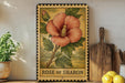 A framed illustration of a large pink hibiscus flower is displayed on a shelf, accompanied by a wooden cutting board and a potted plant.