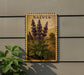 A framed botanical illustration of purple flowers is displayed on a wall, with a plant visible to the left.