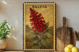 A framed illustration of a red flower is displayed on a shelf, accompanied by a wooden cutting board, a potted plant, and a bowl of lemons.