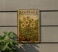 a decorative metal plaque with a floral design, mounted on a wall next to a plant.