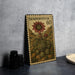 A metal stamp with a floral design and the text "SEMPERVIVUM 60" is displayed on a table.