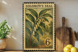 A framed print of a plant with yellow flowers is displayed on a shelf next to a wooden cutting board and some lemons.