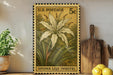 A vintage U.S. postage stamp featuring a large white lily flower, placed on a wooden surface next to a wooden cutting board and a potted plant.