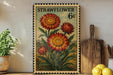 a vintage-style stamp with a floral design, placed on a shelf next to a wooden cutting board and some potted plants.