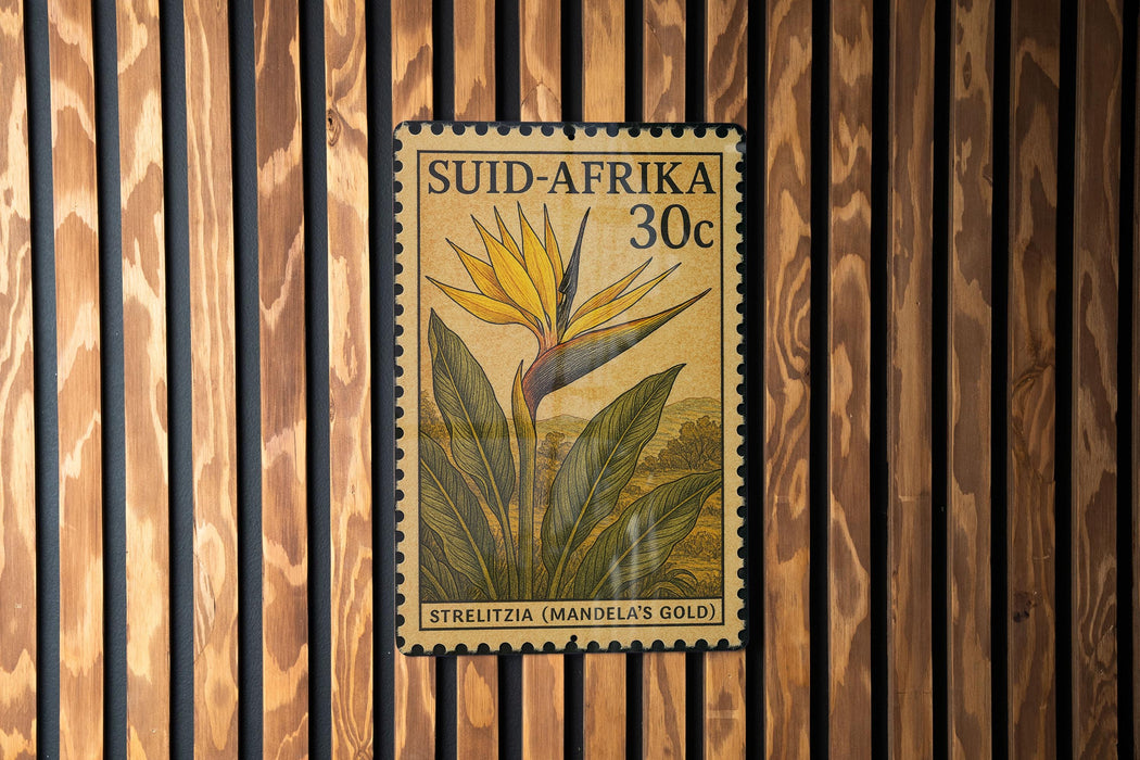 A postage stamp from South Africa featuring a yellow flower and green leaves, with the text "Süid-afrika 30c" and "Strelitzia (MANDELA'S GOLD)" printed on it.