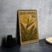A metal stamp with a yellow flower and green leaves, labeled "Süid-afrika 30c STREITZIA (MANDELA'S GOLD)" on a gray wall.