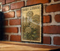 A framed illustration of a flower is hanging on a brick wall, with the text "Sweet Alyssum" visible on the frame.