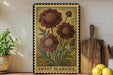 A framed illustration of a red flower with green leaves is displayed on a shelf, accompanied by a wooden cutting board, a potted plant, and a bowl of lemons.