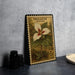 A framed postage stamp featuring a Trillium flower, which is a type of wildflower, is displayed on a table.