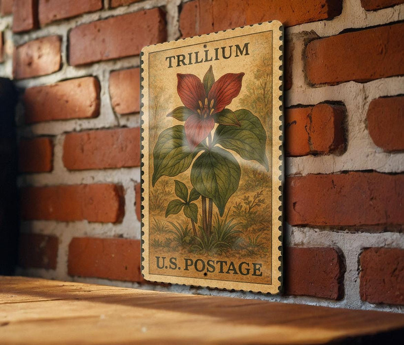 A framed illustration of a trillium flower on a brick wall, with the text "TRILLIUM" and "U.S. POSTAGE" printed on it.