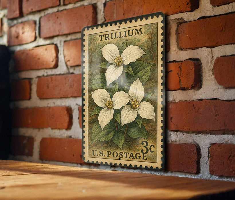 A vintage-style postage stamp featuring a white trillium flower is displayed on a brick wall.