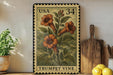 A framed stamp depicting a trumpet vine is displayed on a shelf, surrounded by kitchen utensils and a potted plant.