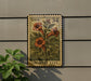 A metal stamp with a floral design and the text "USA 34" is displayed on a wall, with a plant to the left.