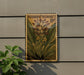 A postage stamp featuring a turmeric flower is displayed on a wall, with a potted plant to the left.