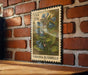 A vintage-style postage stamp featuring a bluebell plant is displayed on a brick wall.