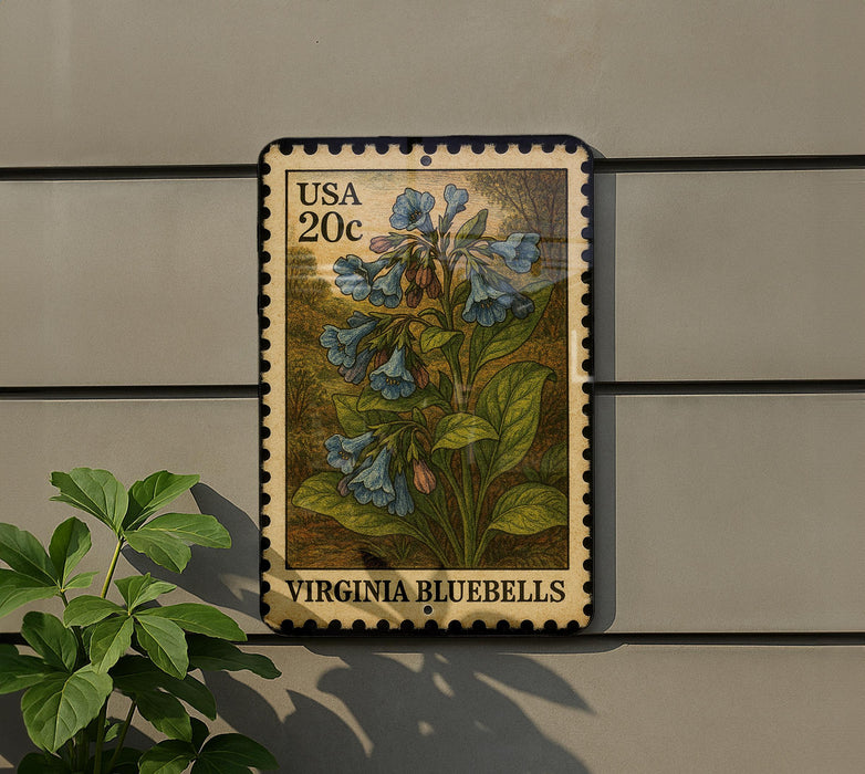 A postage stamp featuring a bluebell plant is displayed on a wall, with a small green plant to the left.
