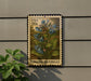 A postage stamp featuring a bluebell plant is displayed on a wall, with a small green plant to the left.
