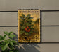 A vintage U.S. postage stamp depicting a plant with red berries, mounted on a wall next to a potted plant.