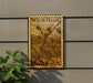 a stamp with a plant illustration on it, mounted on a wall.
