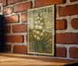 A vintage Yucca 6c postage stamp featuring a detailed illustration of a flower is displayed on a brick wall.