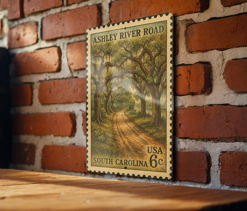 A vintage-style postage stamp depicting a scenic road through a lush, wooded area, mounted on a brick wall.