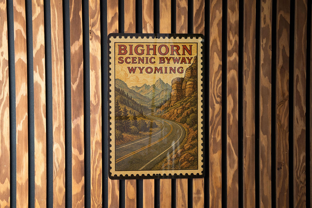 A vintage-style poster of the Bighorn Scenic Byway in Wyoming, featuring a winding road surrounded by mountains and forests.