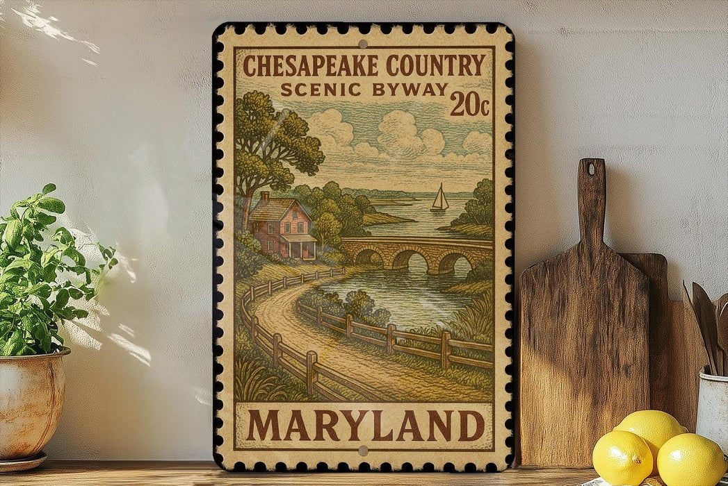 A framed illustration of a scenic countryside in Maryland, featuring a bridge, a house, and a river, is displayed on a shelf next to a wooden cutting board and a potted plant.