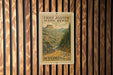 A vintage postage stamp from Wyoming, featuring a scenic mountain landscape, is displayed on a wooden wall.