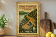 A vintage postage stamp depicting a scenic road winding through a mountainous landscape, with a small car traveling along the road. The stamp is mounted on a wooden surface, surrounded by various kitchen utensils and a potted plant.