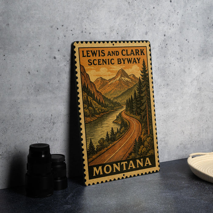 A metal sign with a scenic mountain landscape and a winding road, featuring the text "LEWIS AND CLARK SCENIC BYWAY MISSOURI".