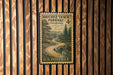 A vintage U.S. postage stamp from the Natchez Track Parkway in Tennessee, featuring a winding road surrounded by trees and mountains.