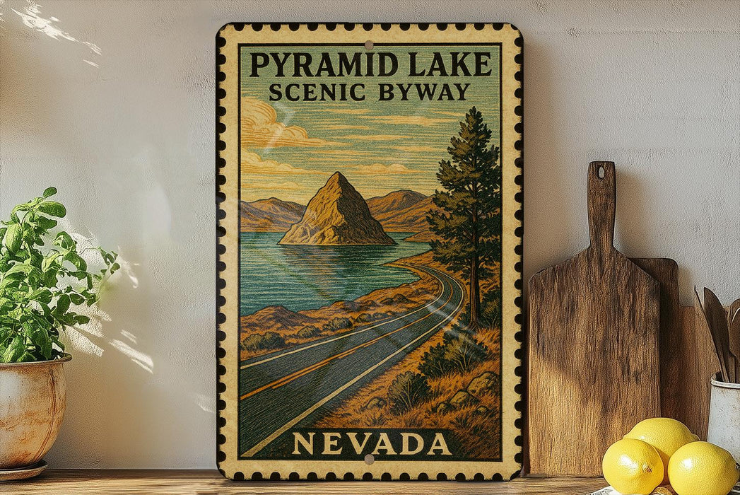A framed vintage-style poster of Pyramid Lake, Nevada, depicting a scenic road leading to a mountain island, is displayed on a shelf next to a wooden cutting board and a potted plant.