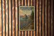 A vintage-style metal sign for Pyramid Lake Scenic Byway in Nevada, featuring a scenic landscape with mountains, a lake, and a road.