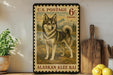 A vintage U.S. postage stamp featuring an Alaskan Klee Kai dog, with a wooden paddle and lemons on a shelf in the background.