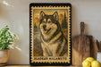 A framed image of an Alaskan Malamute dog, with the text "Alaskan Malamute" printed on the frame.