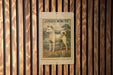 A wooden fence with a framed illustration of a white dog, labeled "JINDO WHITE", hanging on it.