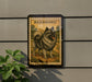 A framed illustration of a dog, specifically a Keeshond breed, is displayed on a wall.