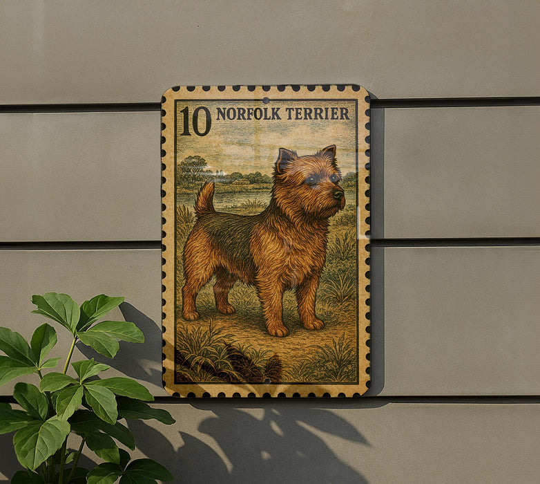 a 10 Norfolk Terrier dog standing in a field, depicted in a stamp-like frame.