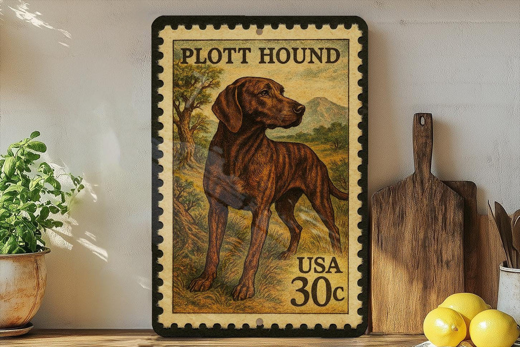 A framed stamp depicting a hound dog, with the text "PLOTT HOUND" and "USA 30c" printed on it. The stamp is placed on a shelf next to a wooden cutting board and a potted plant.