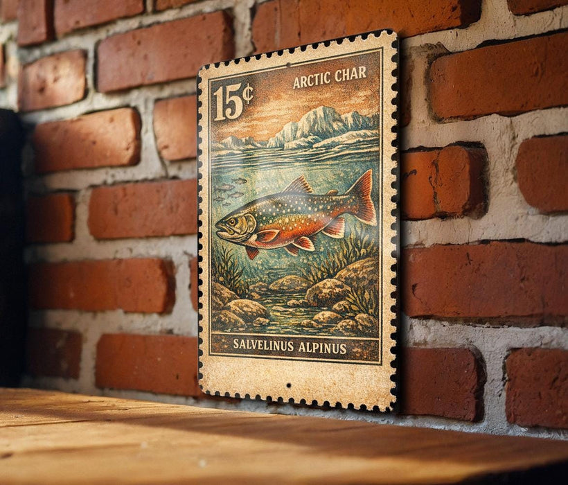 A 15 cent postage stamp from the Arctic Char, featuring a salvelinus alpinus fish, is displayed on a brick wall.