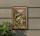 A metal sign with an illustration of a salmon jumping out of the water, mounted on a wall.