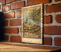 A U.S. postage stamp featuring a black crappie fish is displayed on a wooden surface against a brick wall.